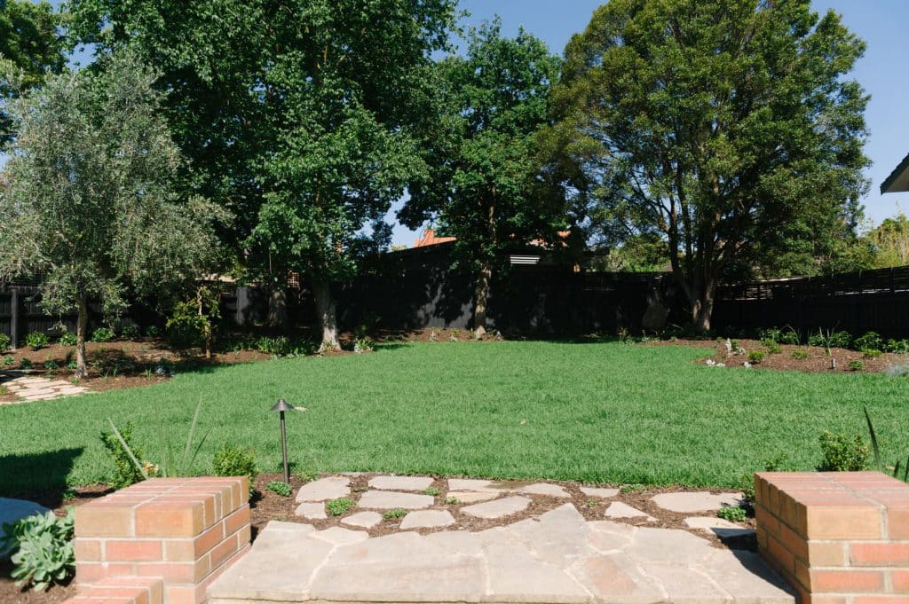 large green lawn at the rear of a premium outdoor patio