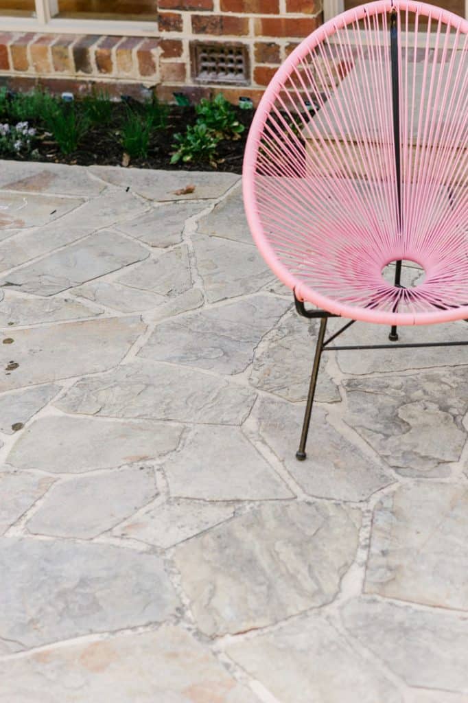 a pink wire chair on custom concrete patio in balwyn