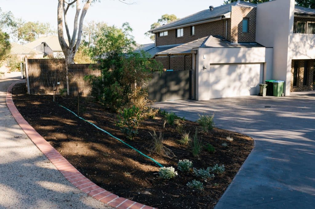 custom landscaped front garden next to a driveway