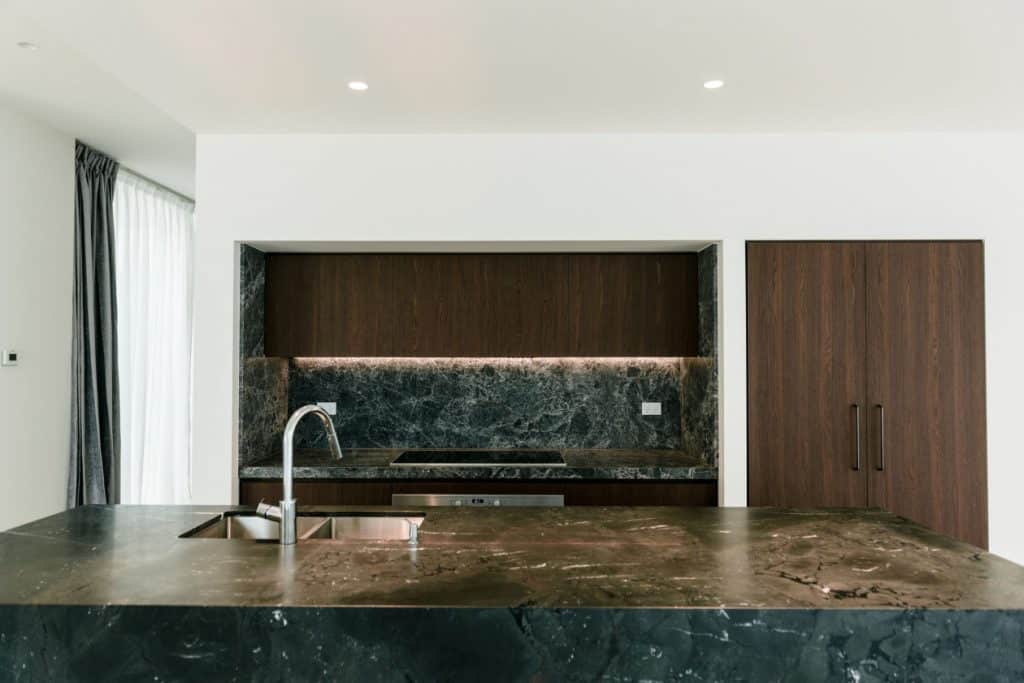 custom black marble island bench in a kitchen