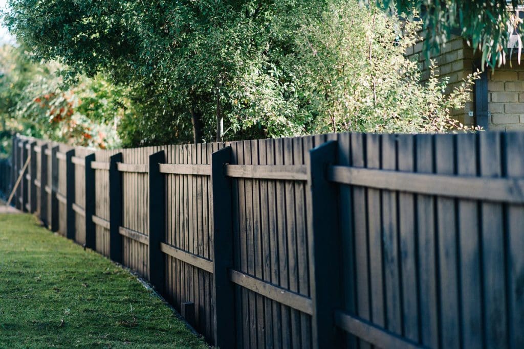a side fence painted black in mornington peninsula