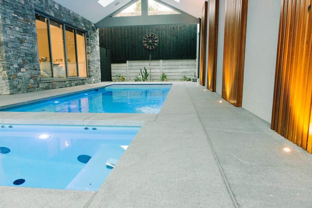 enclosed patio covering a custom inground spa and pool