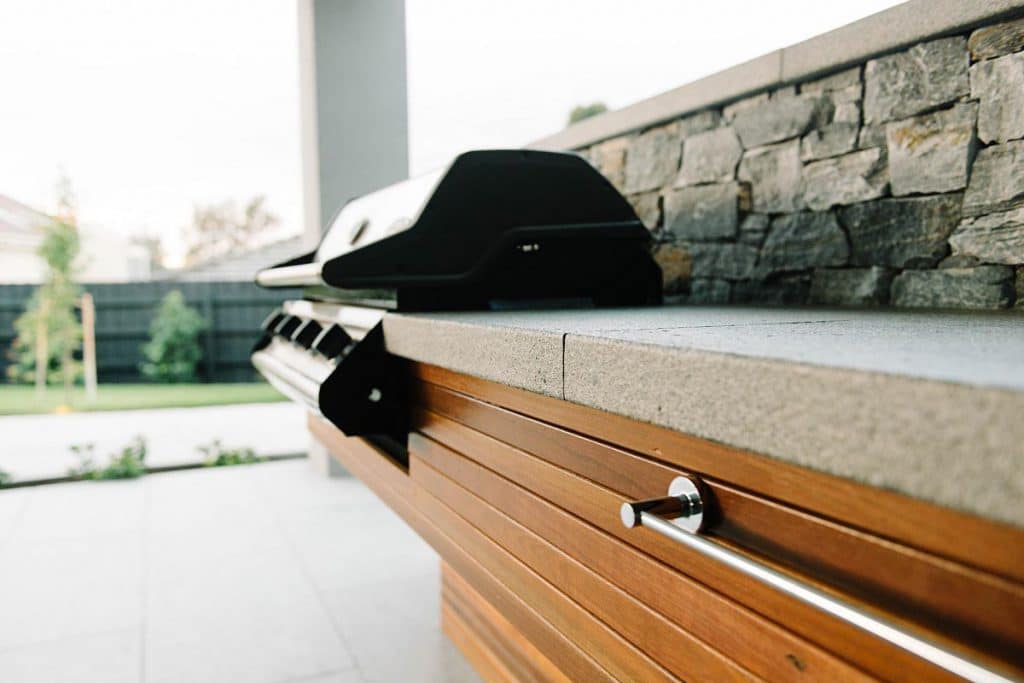 a custom designed bbq bench against a masonry wall
